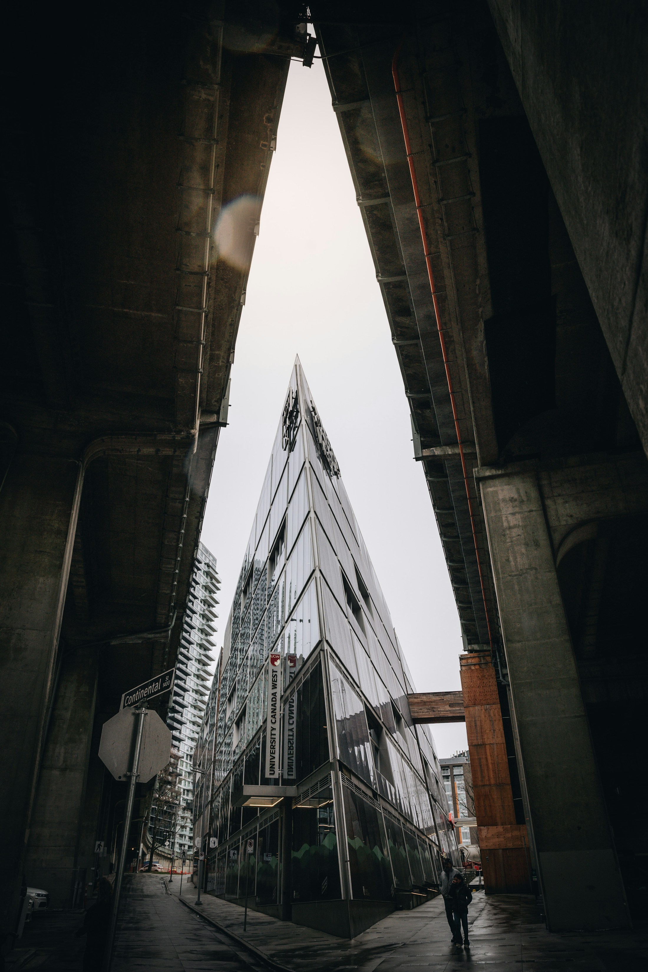 A Vancouver glass building framed by concrete elevated structures.