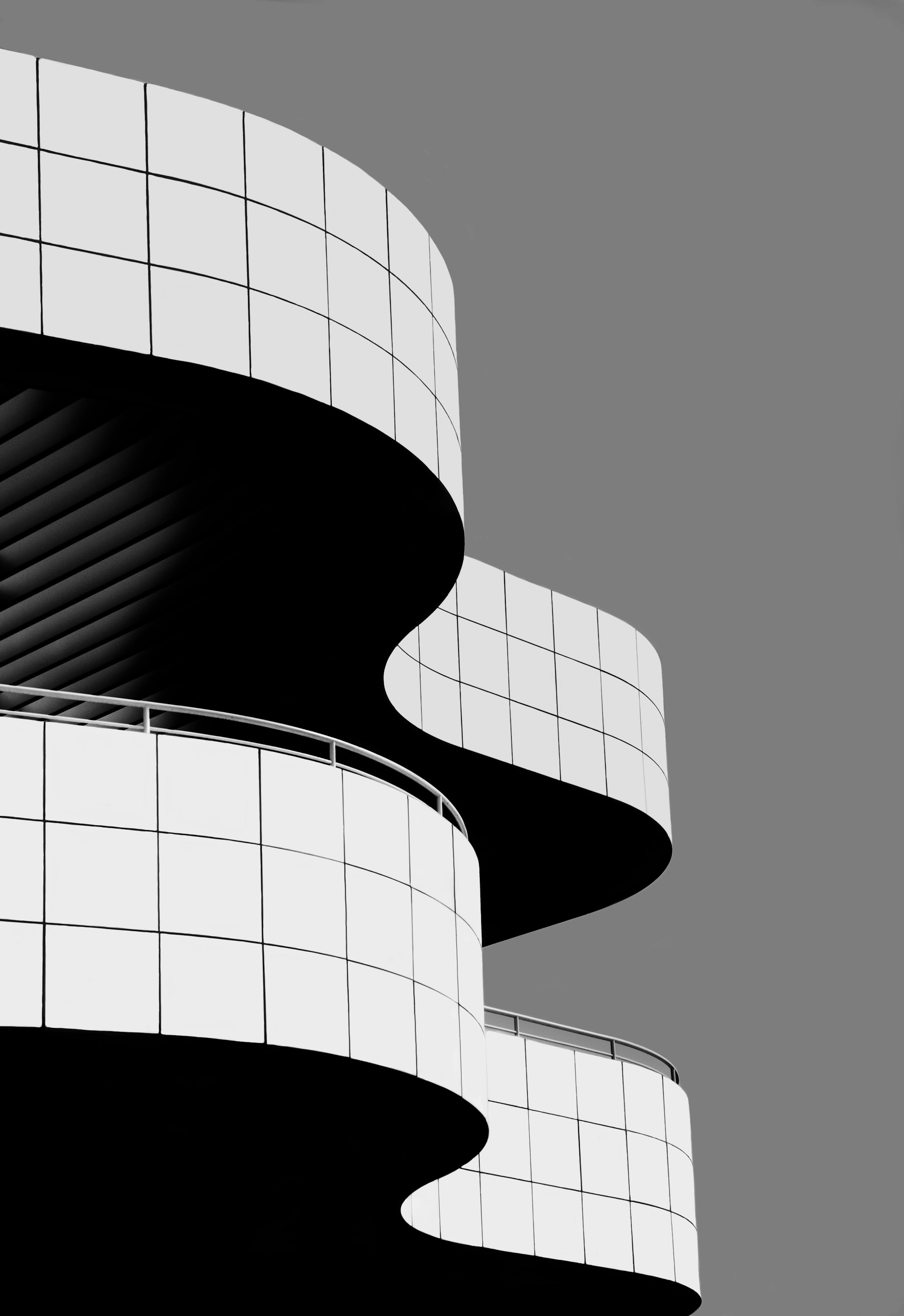 Curved concrete architecture photographed in black and white.