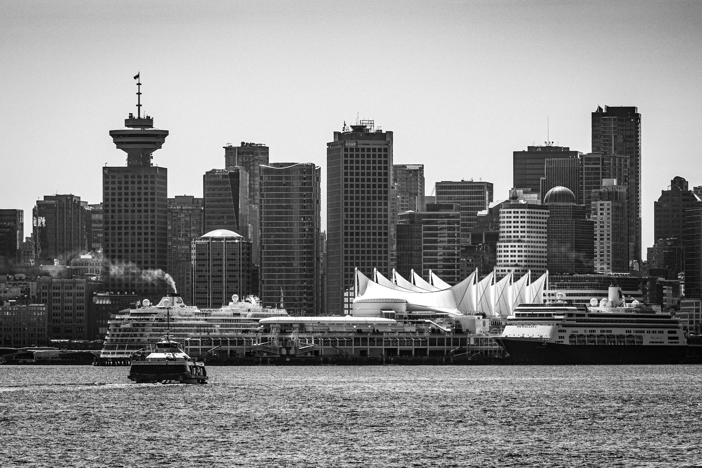 Canada Place and downtown Vancouver across Burrard Inlet, photographed in black and white.
